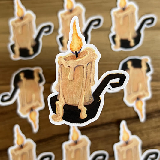 Sticker of a candle with a flame on a wooden background