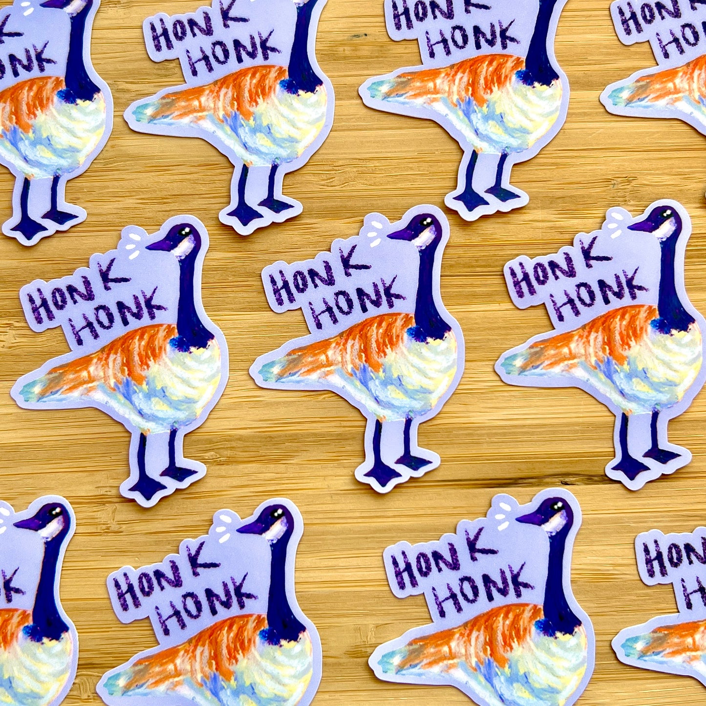 Stickers of a goose with 'Honk Honk' text on a wooden surface