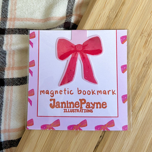 Magnetic bookmark with a red bow design on a pink card, featuring Janine Payne Illustrations.