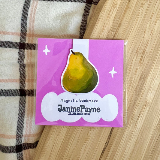 Magnetic bookmark with pear illustration and 'Janine Payne Illustrations' text on a wooden surface.