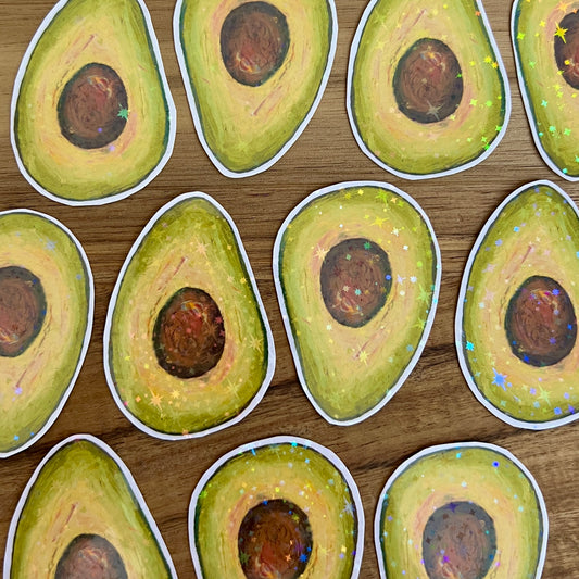 Sticker design of sliced avocados on a wooden surface