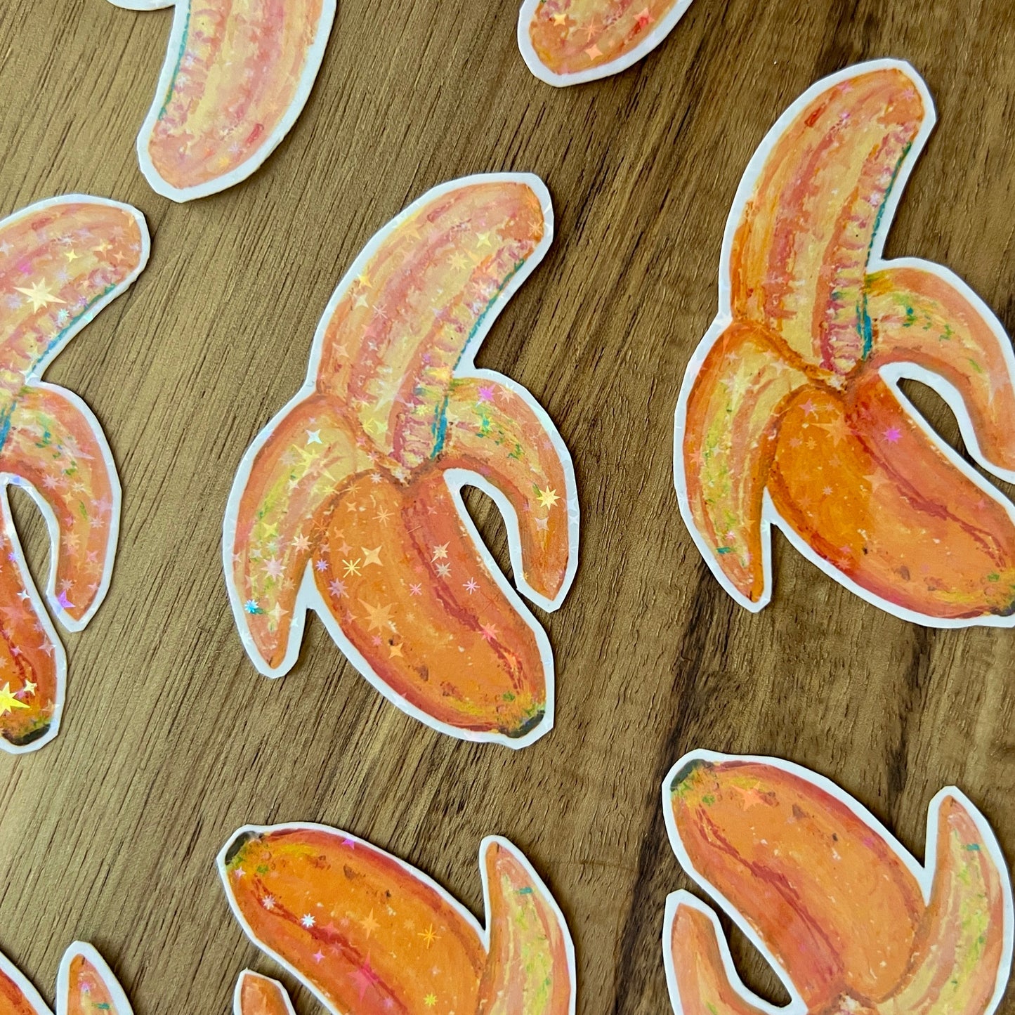 Banana-shaped stickers on a wooden surface