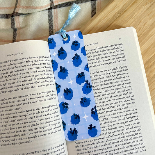 Blueberry bookmark on an open book with a plaid fabric background