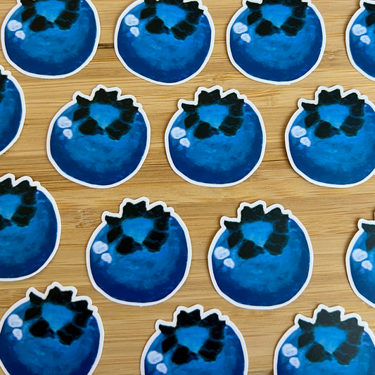 Pattern of blue and black round stickers on a wooden surface