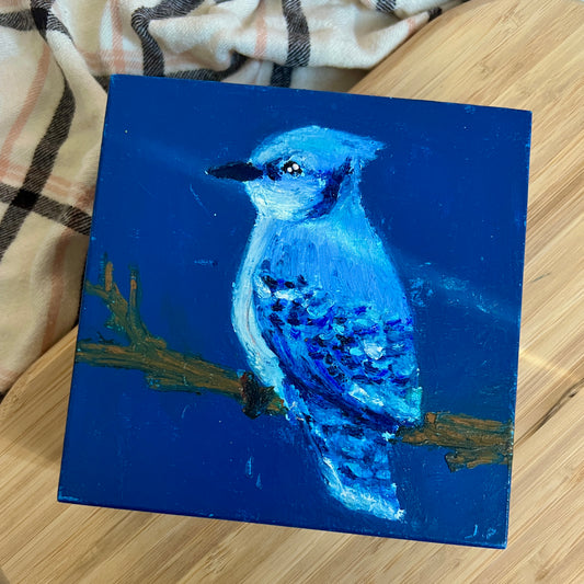 Painting of a blue bird on a blue background