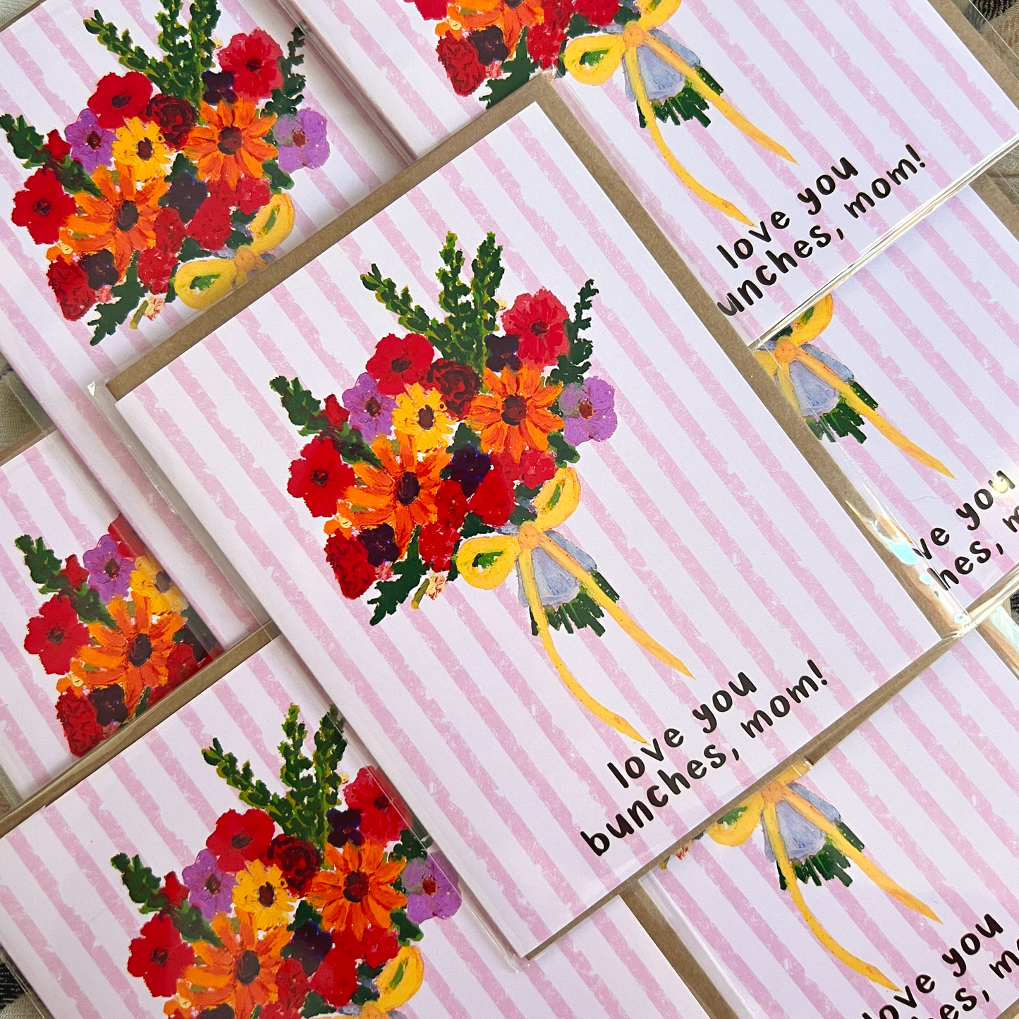 Set of cards with floral designs and 'love you bunches, mom!' text on a striped background