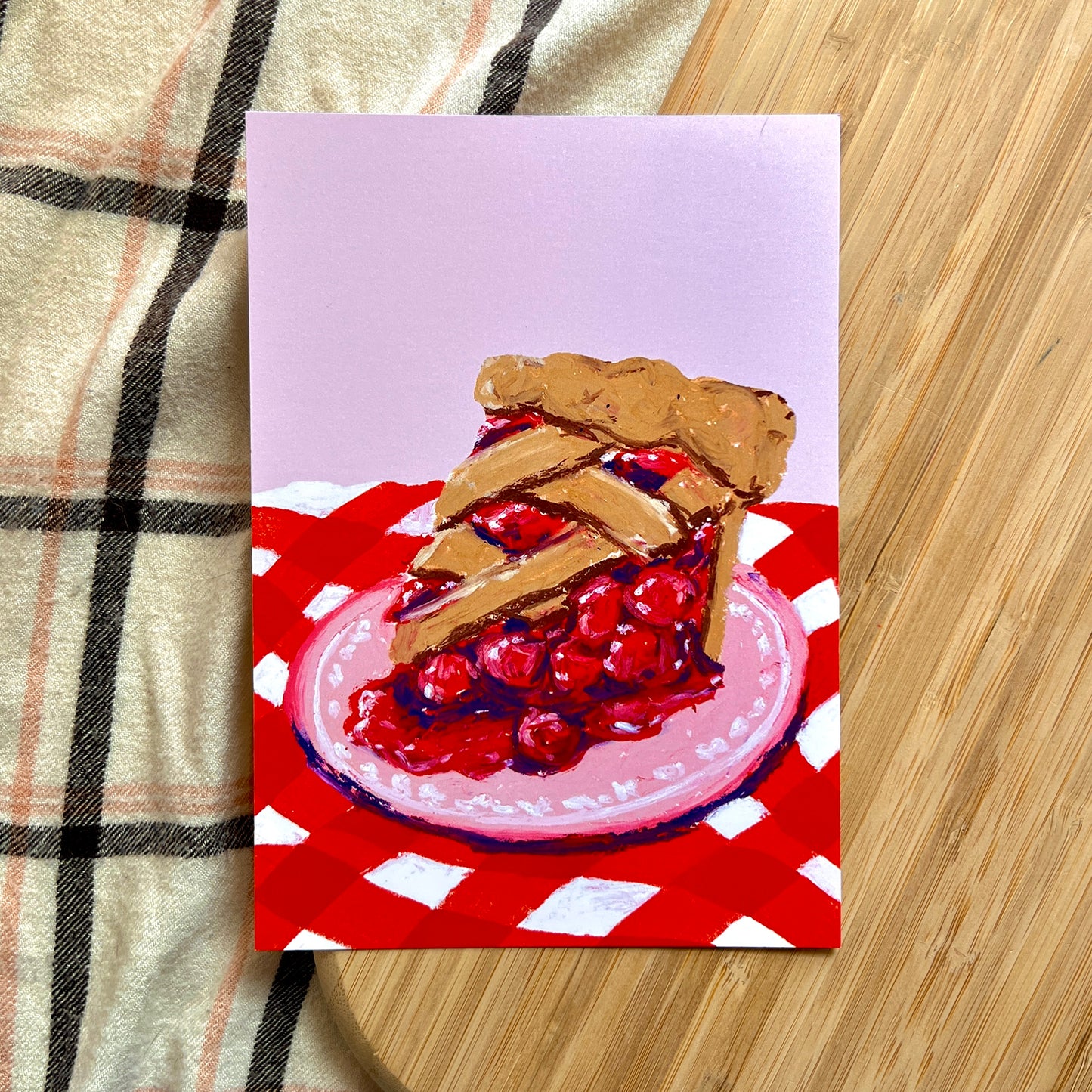 illustration of cherry pie on red checkered cloth