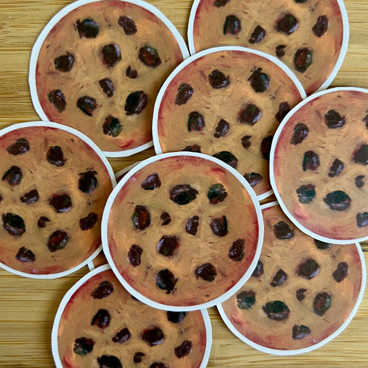 Multiple round cookies with chocolate chips on a wooden surface