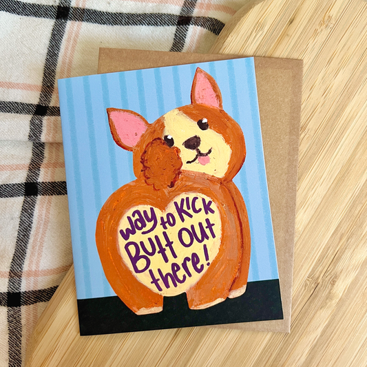 Card with a drawn corgi with heart shaped butt on a blue striped background with text 'way to kick butt out there'