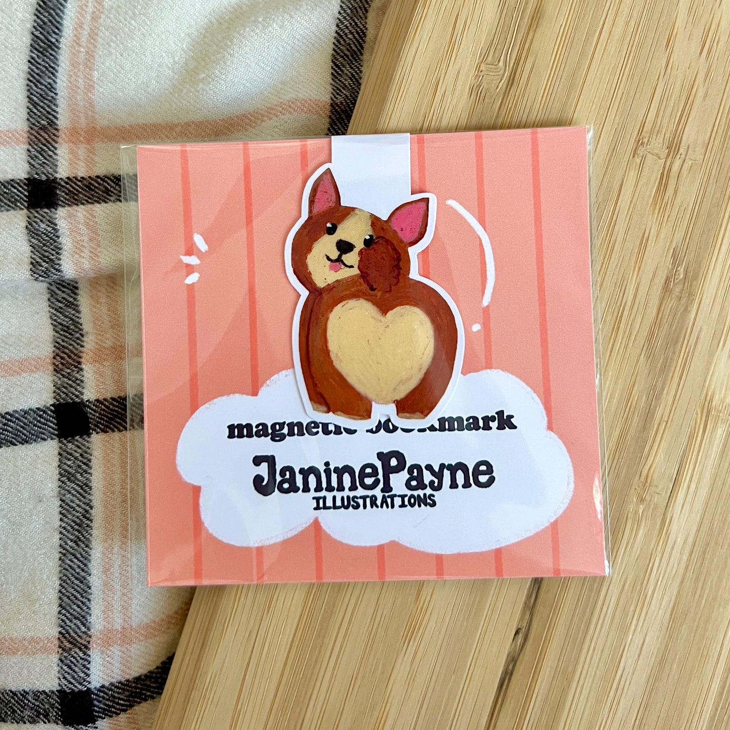 Magnetic bookmark with dog illustration on a striped background