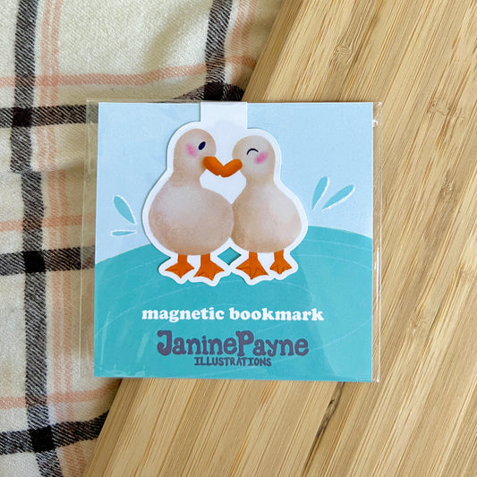Magnetic bookmark with duck illustration on a wooden surface
