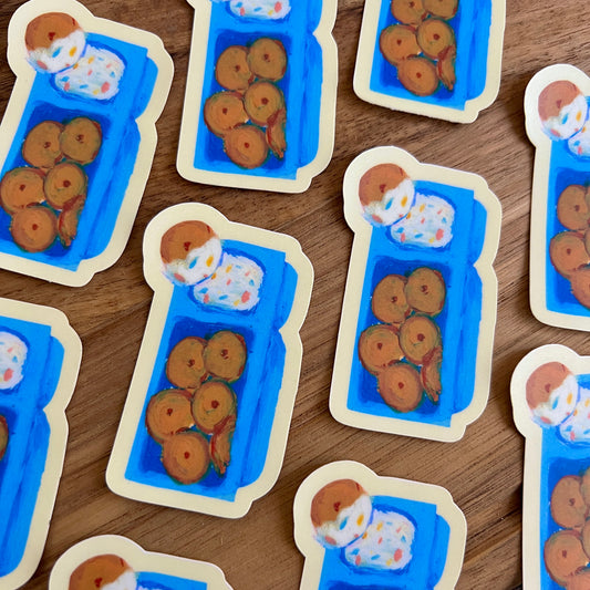 Stickers of cookies in blue trays on a wooden surface