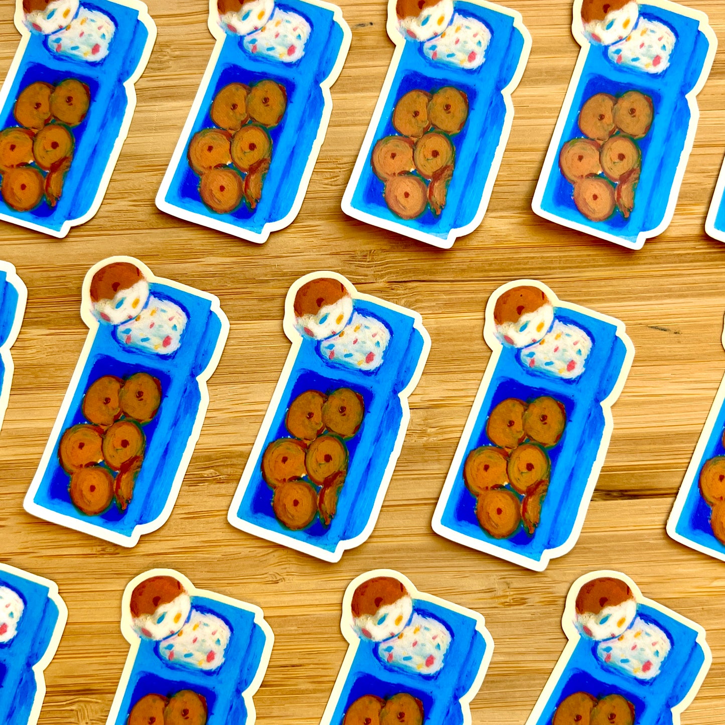 Stickers of blue lunch boxes with cookies and ice cream on a wooden surface