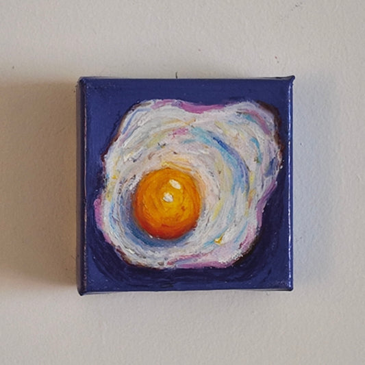 fried egg painting on purple background hung on white wall