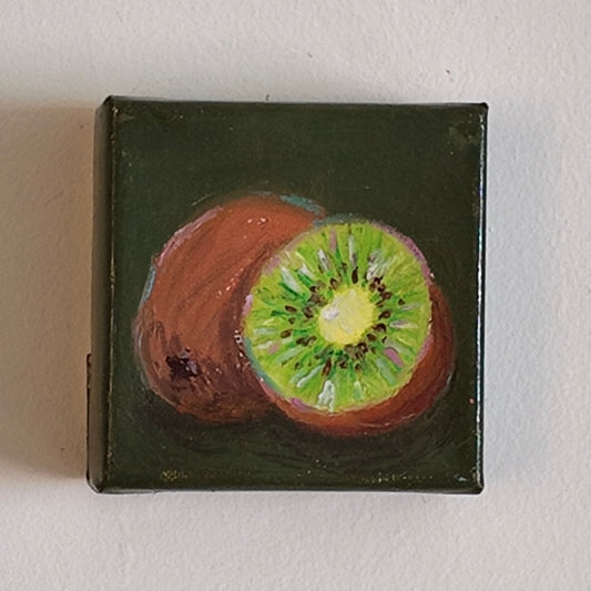 Miniature painting of a kiwi fruit on a dark green background