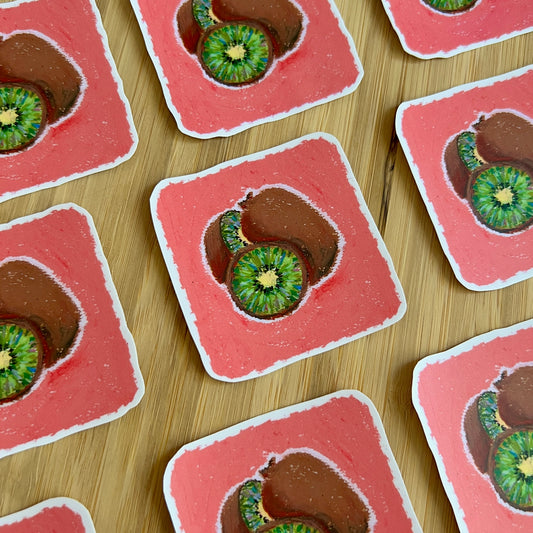 stickers with kiwi slices on a wooden surface