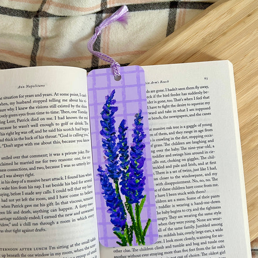 Lavender bookmark on an open book with a plaid fabric background