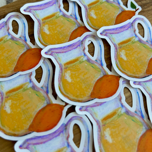 Stickers of pitchers and lemons on a wooden surface