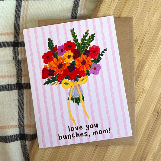 Greeting card with floral design and 'love you bunches, mom!' text on a striped background
