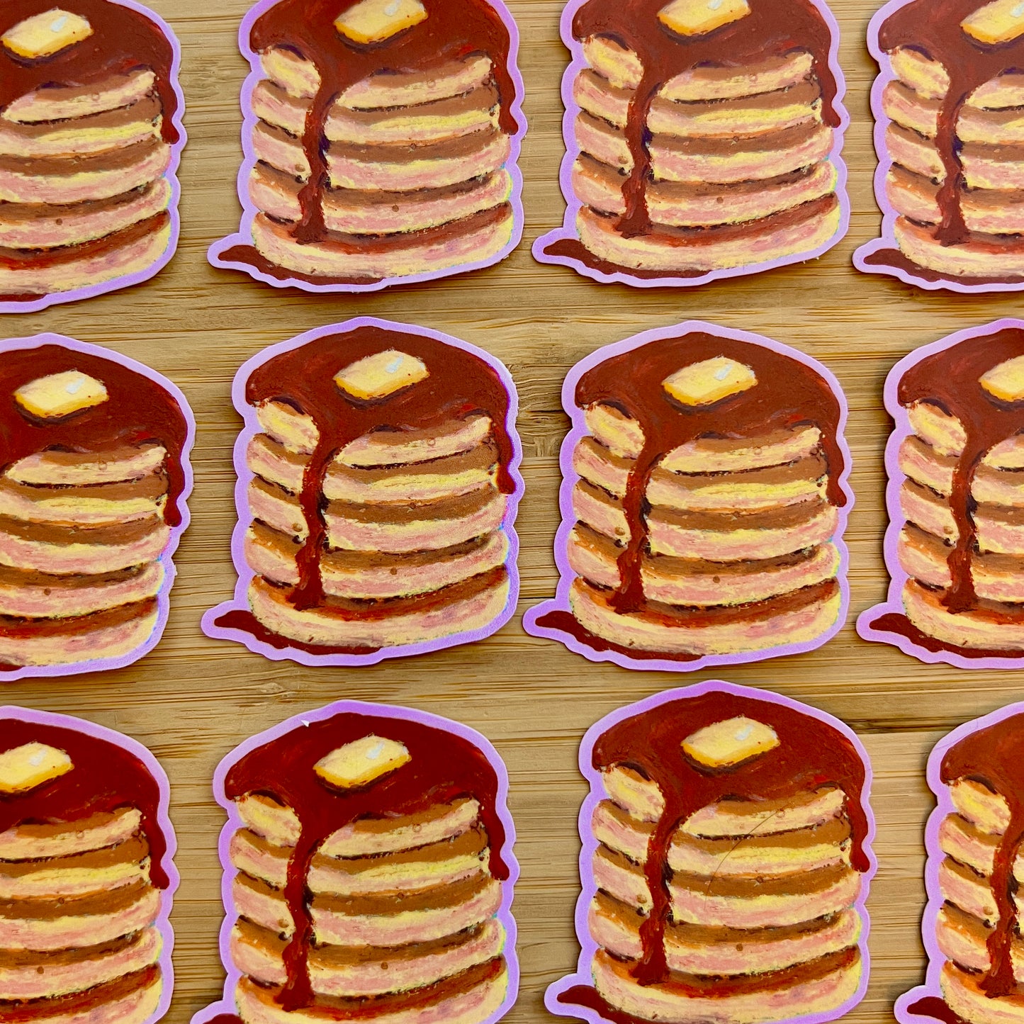 Illustrations of stacks of pancakes with syrup and butter on a wooden surface.