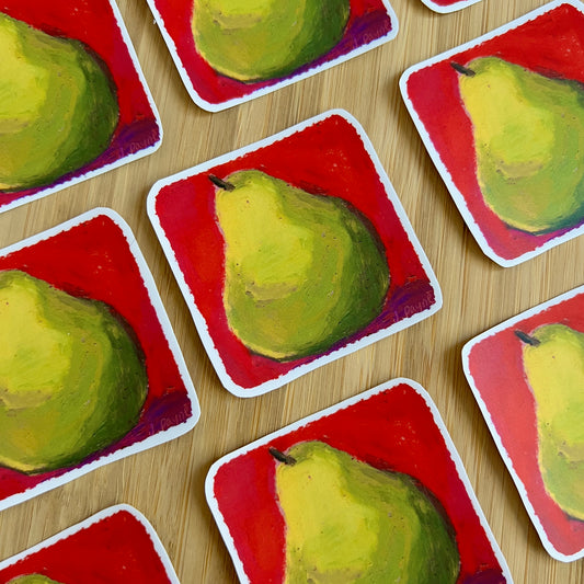 Multiple cards with painted pears on a red background arranged on a wooden surface.