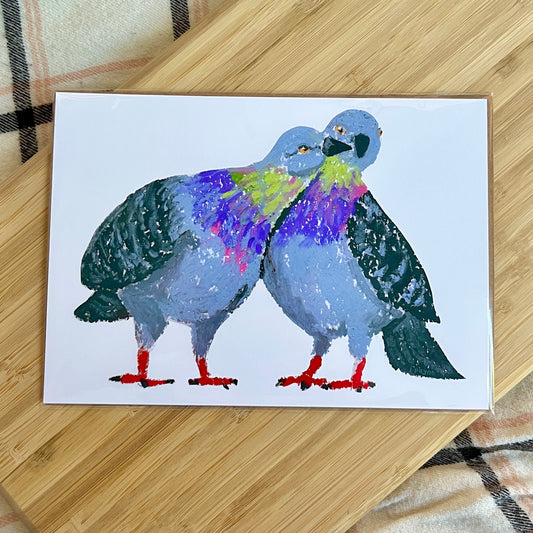 art print with two colorful birds on a wooden surface
