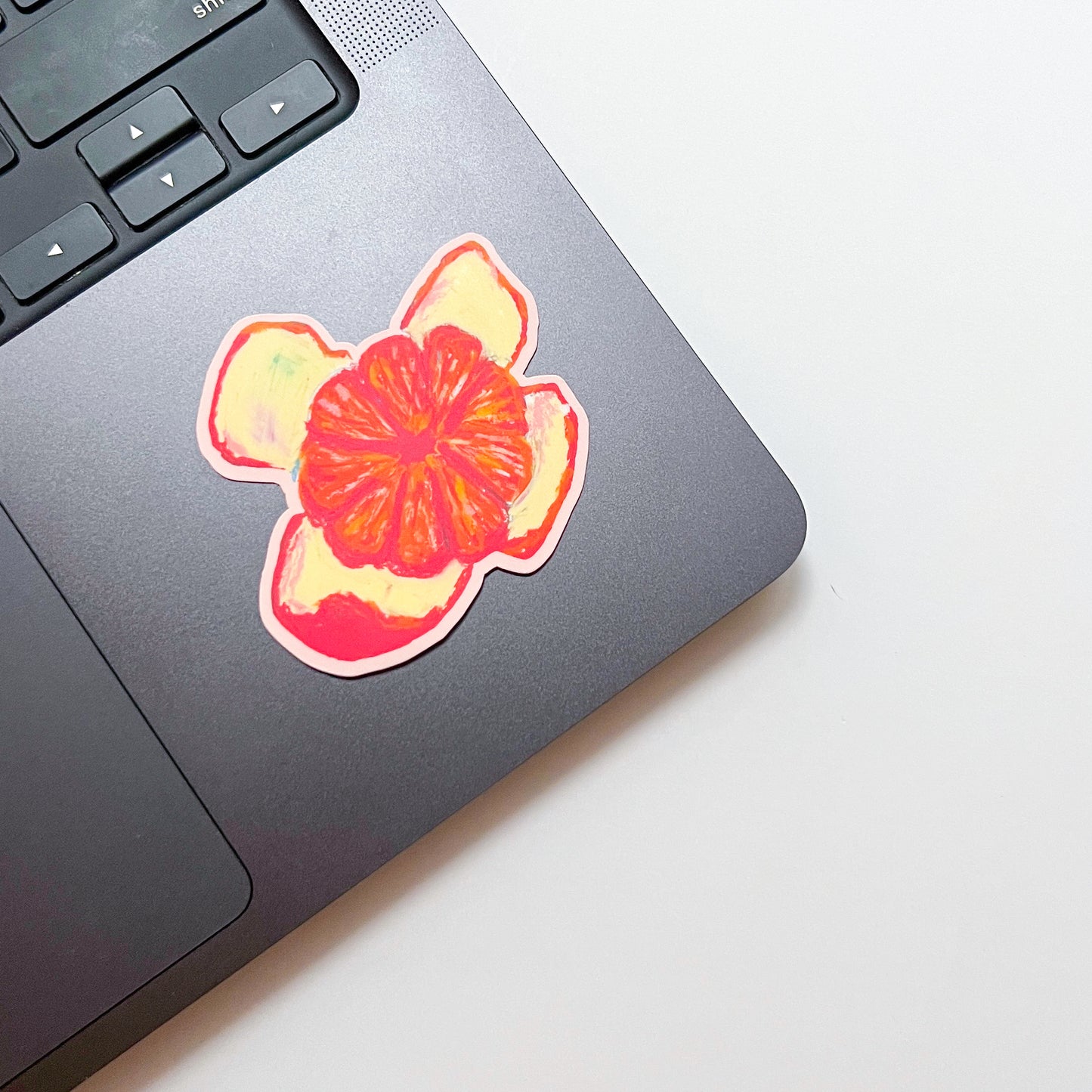 orange sticker on a laptop