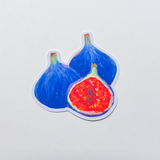Sticker of two figs with one cut open to reveal red flesh on a light gray background