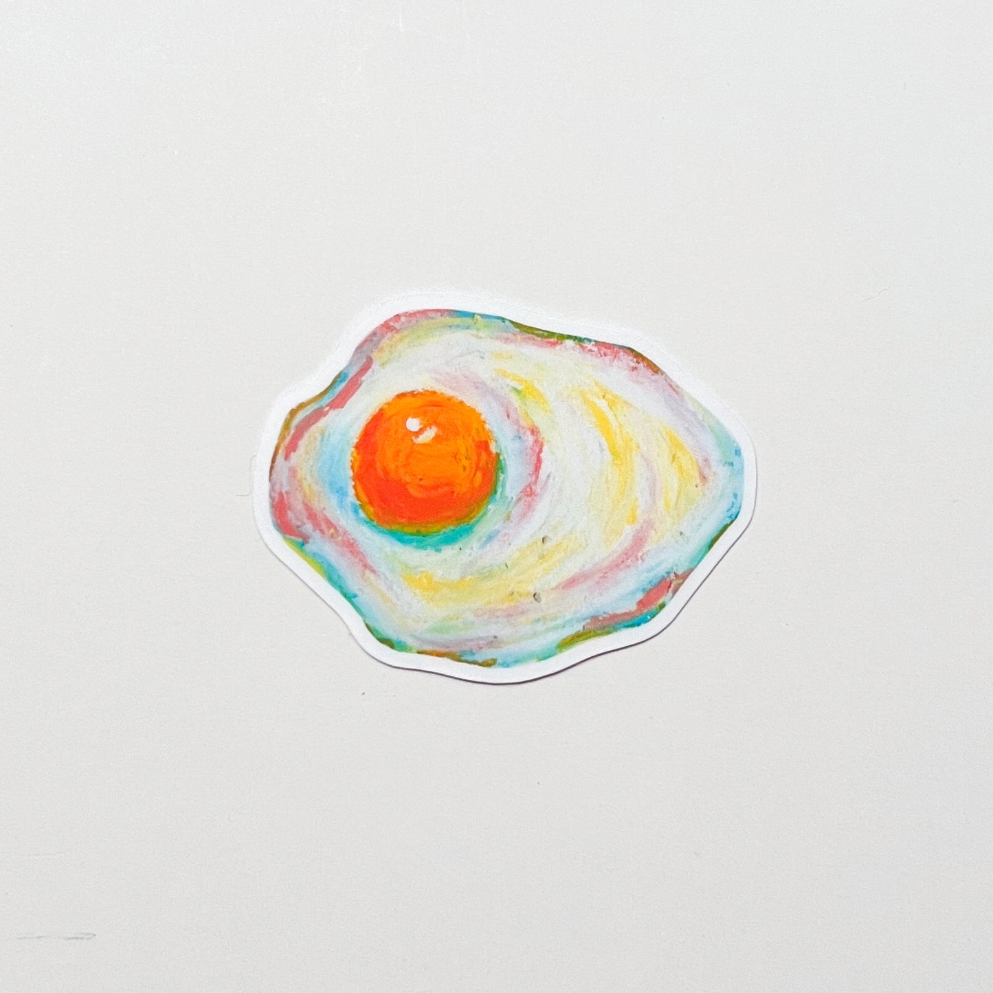 colourful fried egg sticker on white surface