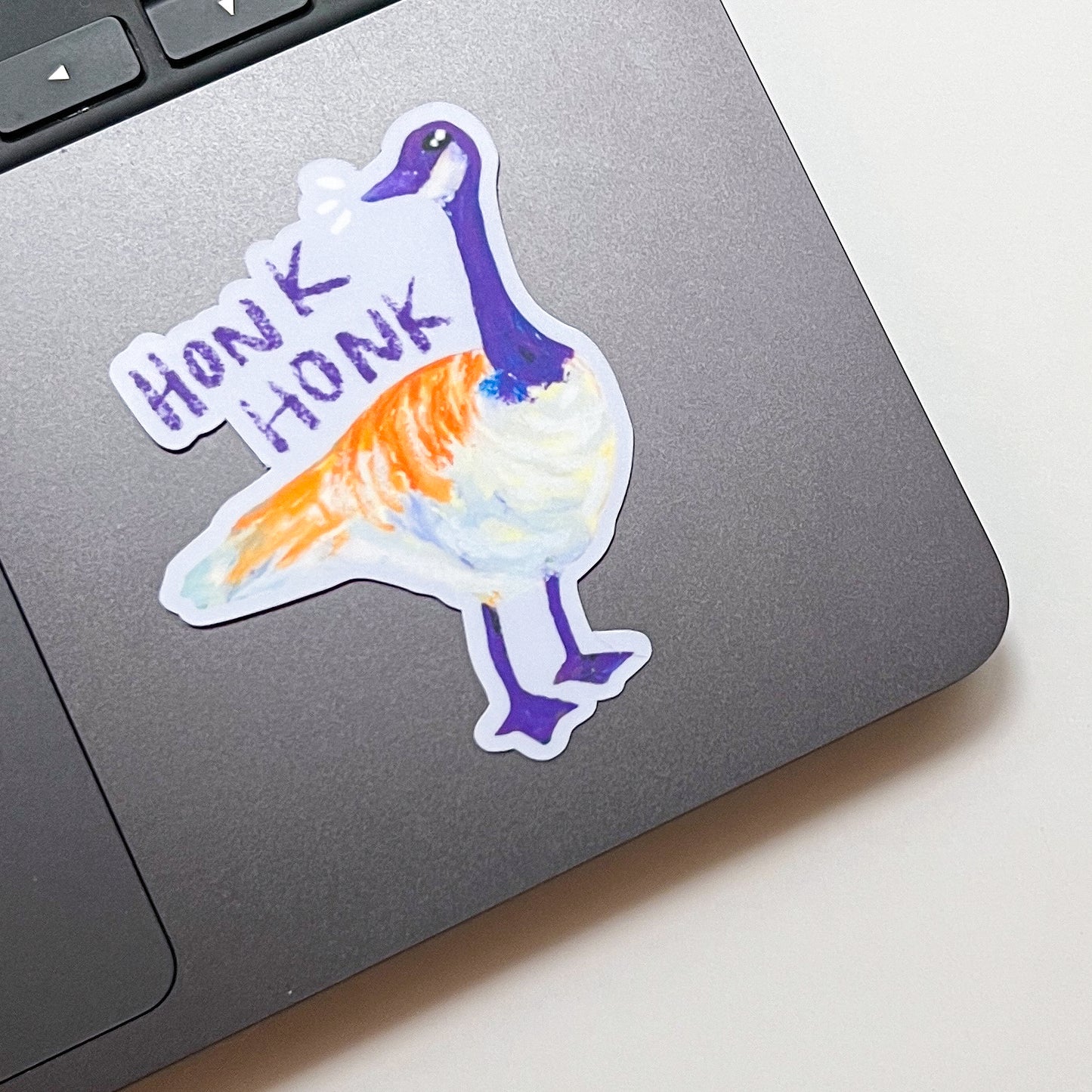 Colorful duck sticker with 'Honk Honk' text on a laptop