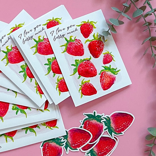 Strawberry stickers and cards with 'I love you berry much' text on a pink background.