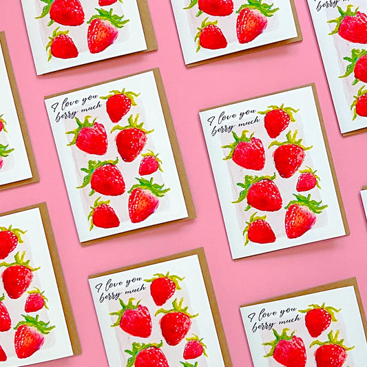 Greeting cards with strawberry design and 'I love you berry much' text on a pink background