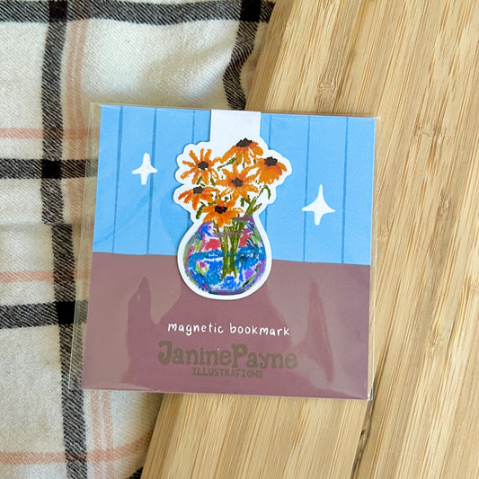 Magnetic bookmark with floral design on a wooden surface