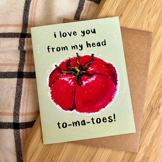 Card with a red tomato illustration and text 'I Love You From my Head to-ma-toes!' on a wooden surface
