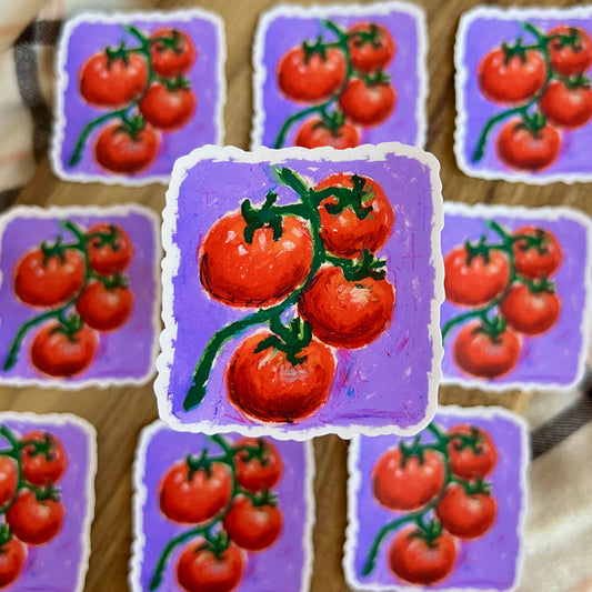 Stickers with red tomatoes on a purple background arranged on a wooden surface.