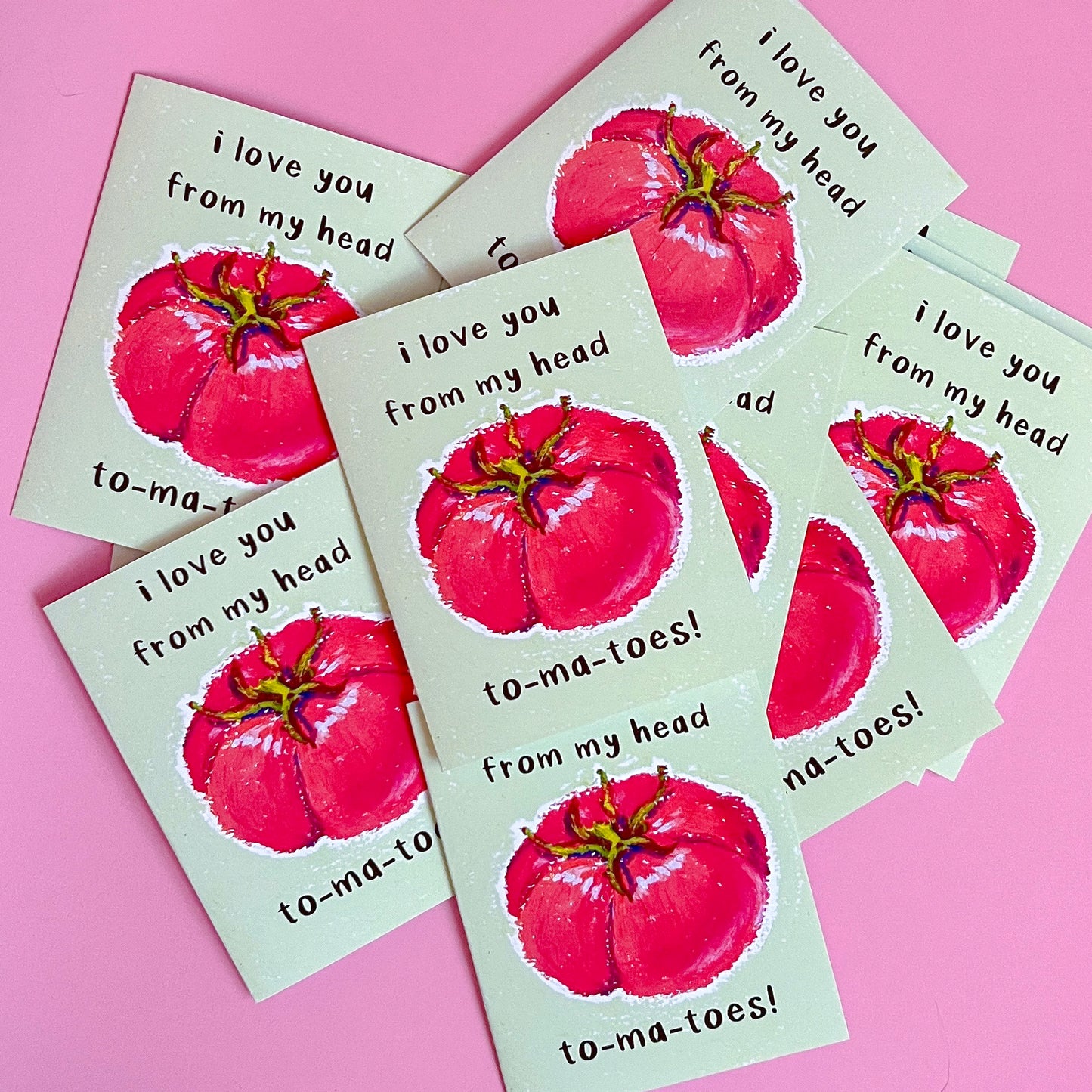 Greeting cards with red tomato illustration and text 'I love you from my head tomatoes' on a pink background
