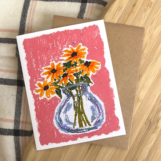Card with a floral design on a wooden surface