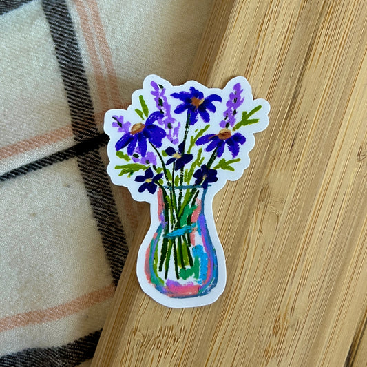 Sticker of a vase with purple flowers on a wooden surface