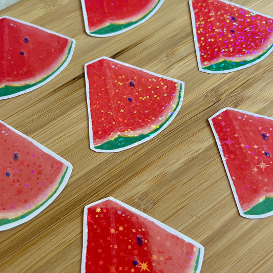 Watermelon slice stickers on a wooden surface