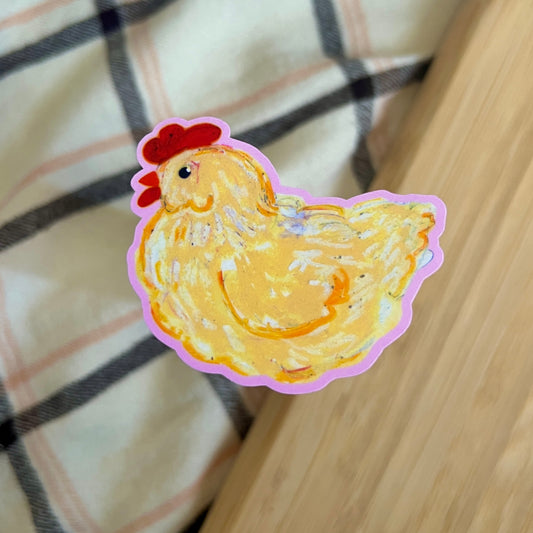 Sticker of a cartoon chicken on a checkered fabric background