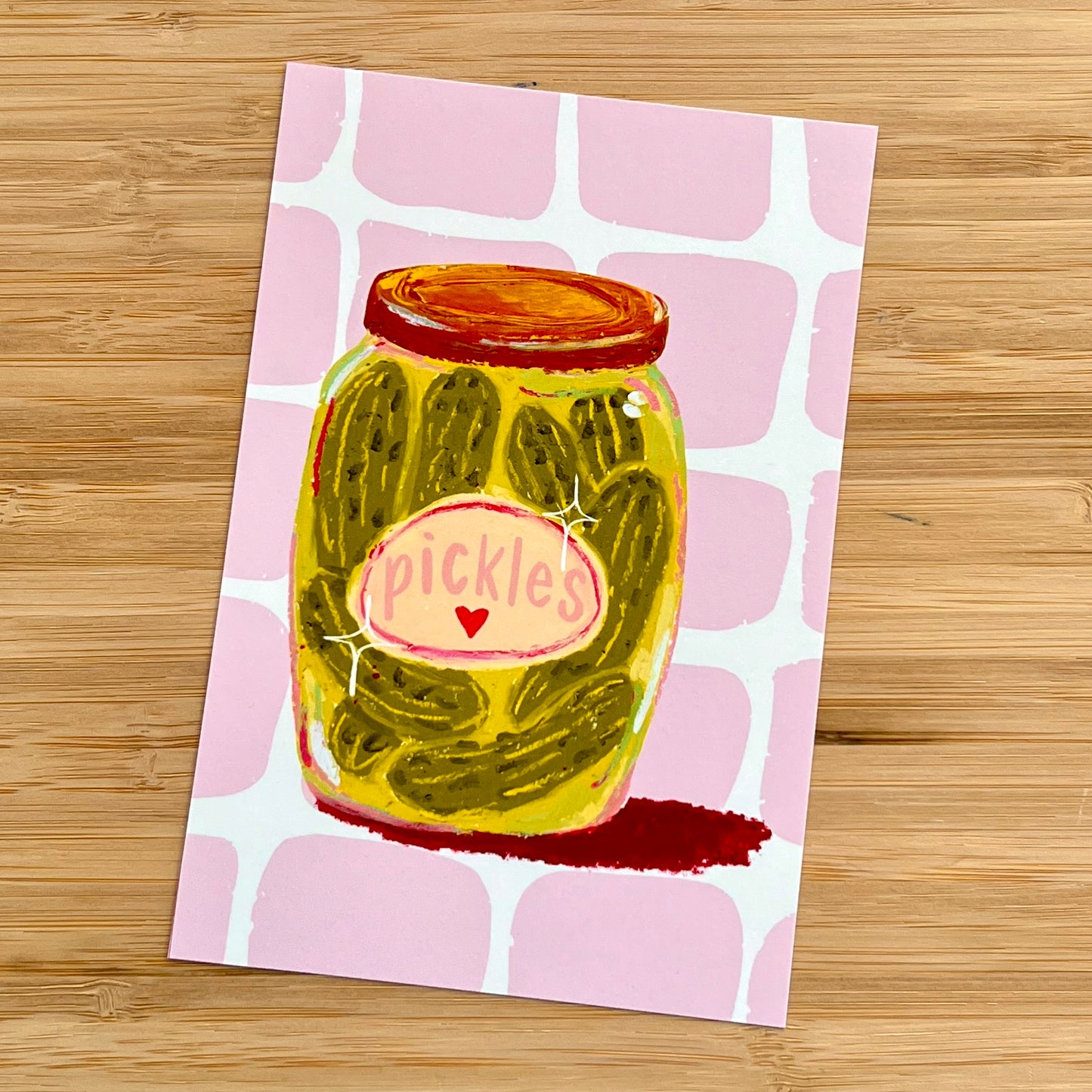 jar of pickles on pink checkered background