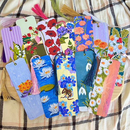 Colorful floral bookmarks with tassels on a checkered fabric background
