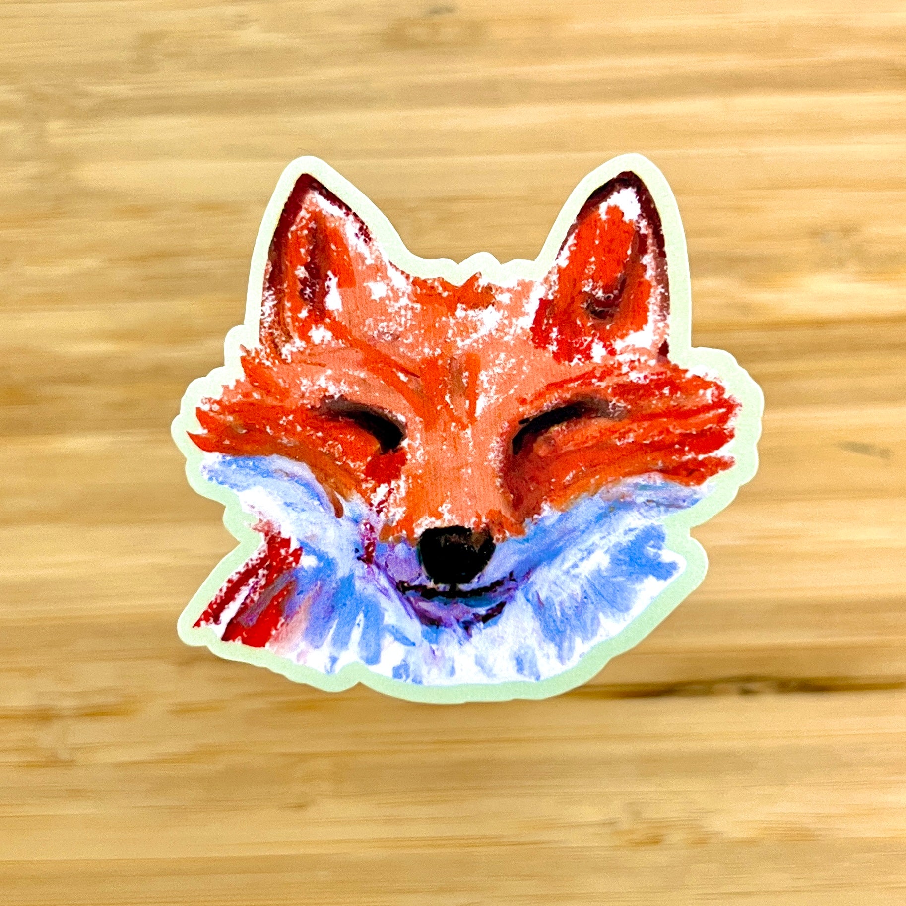 Sticker of a fox face on a wooden background