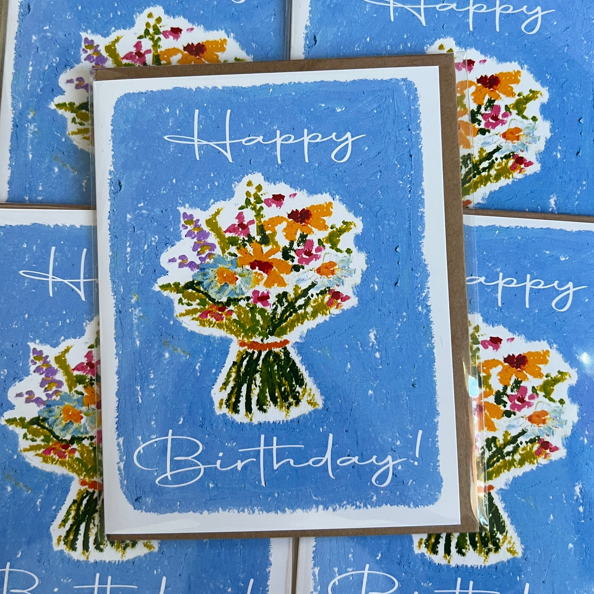 Birthday card with floral design and 'Happy Birthday!' text on a blue background