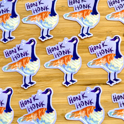 Stickers of a goose with 'Honk Honk' text on a wooden surface