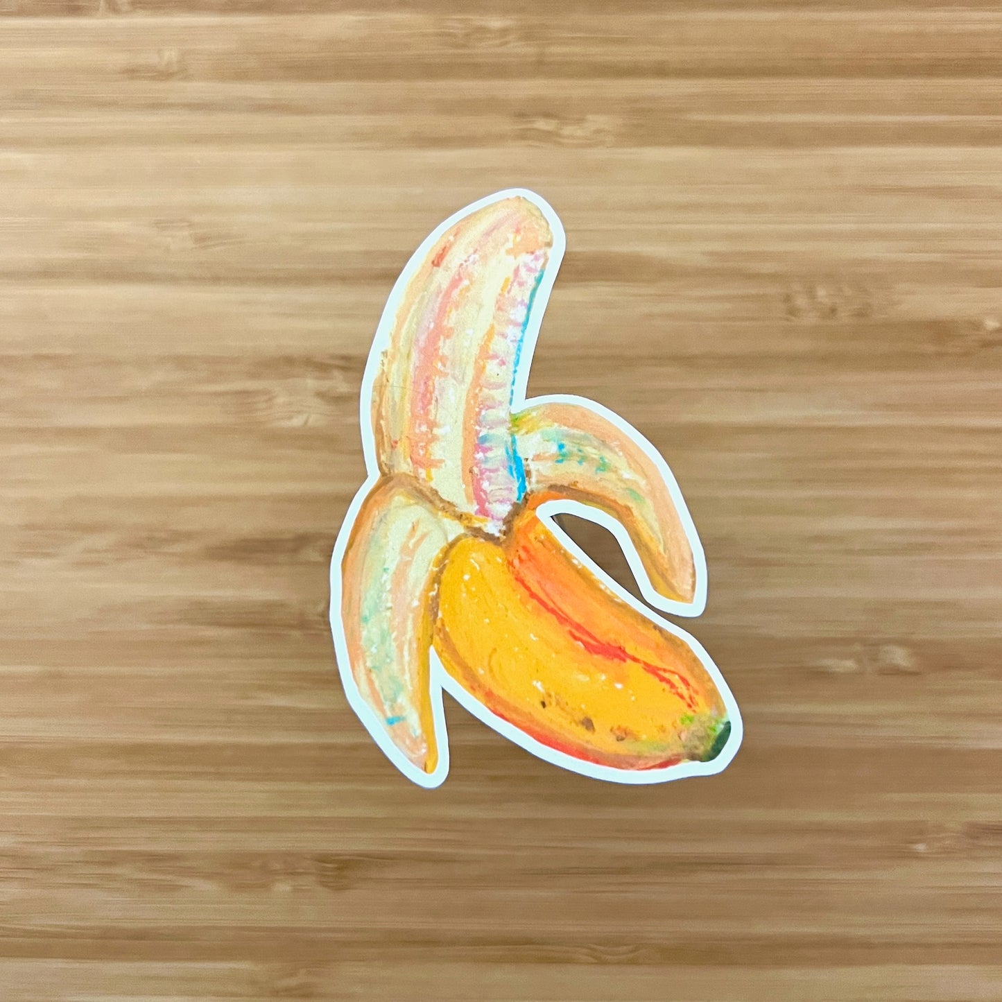 Sticker of a stylized banana on a wooden surface