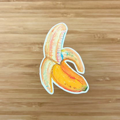 Sticker of a stylized banana on a wooden surface