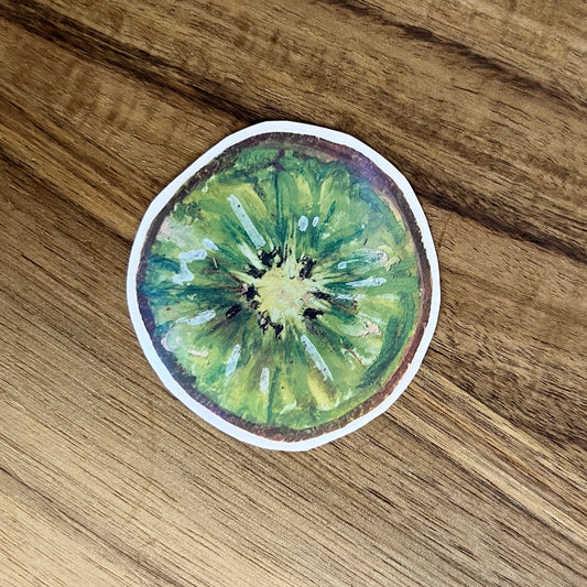 Sticker of a kiwi slice on a wooden surface