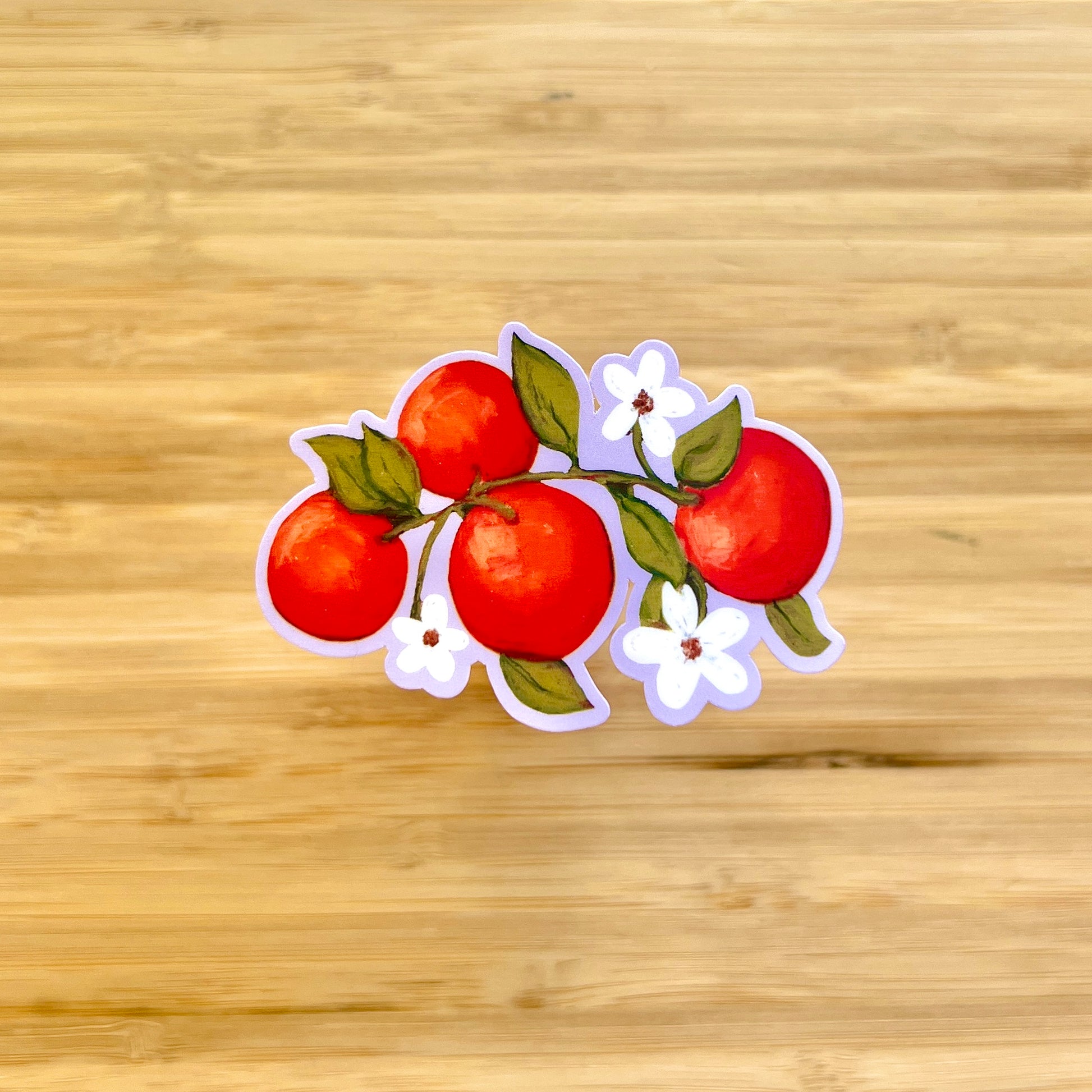 Sticker of oranges with leaves and flowers on a wooden background