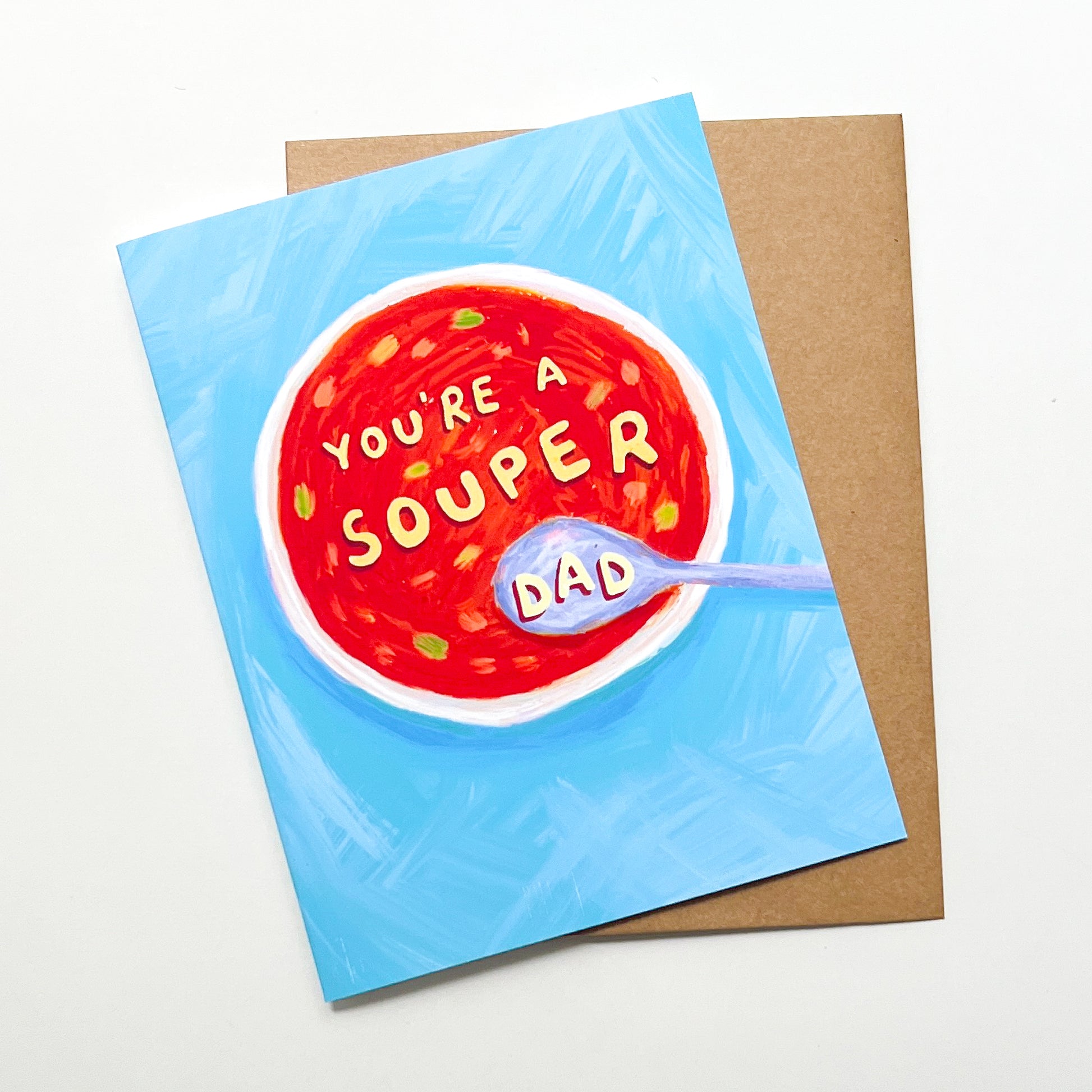 Greeting card with a bowl of soup design and 'You're a souper dad' text on a blue background.